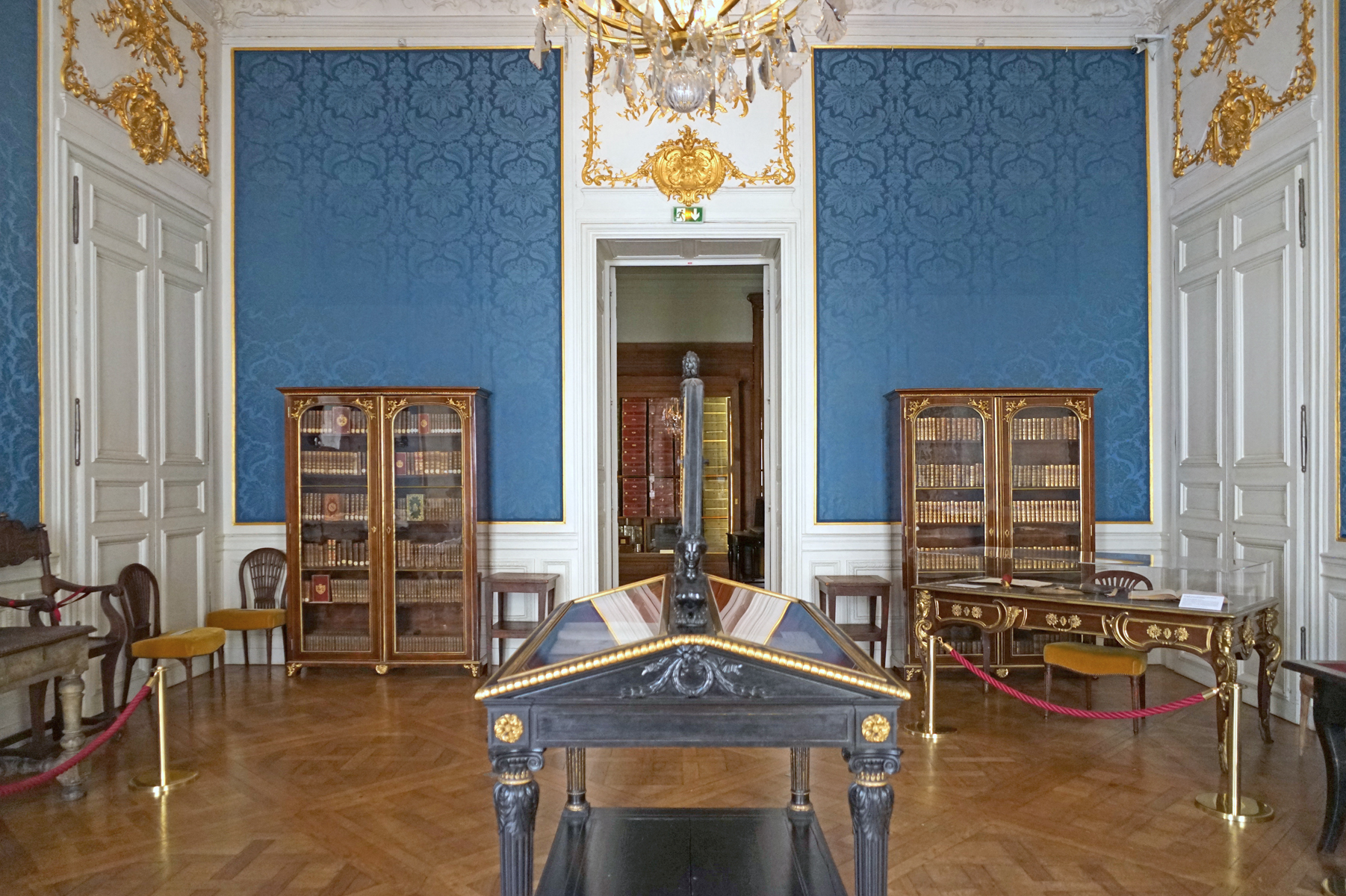 Historic writing furniture and book cabinets in the Salle du Dais at the Hôtel de Soubise in Paris.